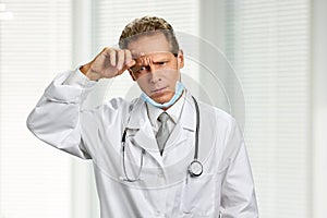 Portrait of upset male caucasian doctor.