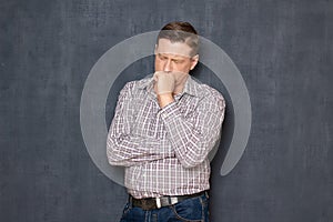 Portrait of upset man thinking about something sorrowful