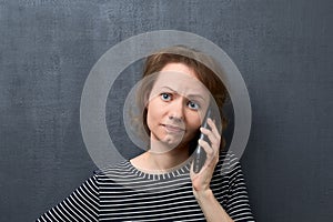 Portrait of upset woman talking on phone