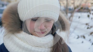 Portrait upset young girl crying on winter street. Close up face unhappy girl crying on winter walk at snowy city street