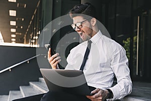 Portrait of uptight businessman dressed in formal suit sitting o