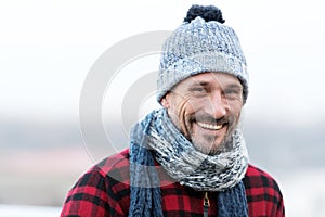 Portrait of urban very smiling guy. Happy Man in hat with ball and scarf. Funny man smiles to you. Closeup of big smile man face