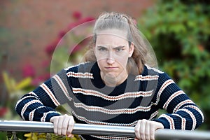 Angry looking young woman , seeks revenge
