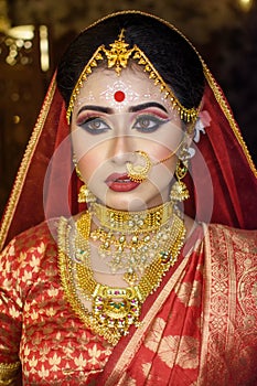 Portrait of very beautiful surprised Indian bride closeup. Concept of human emotions