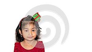 Portrait of a very cute little girl with a gift bow on her head.She is happy