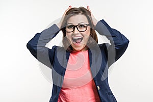 Portrait of very happy surprised adult business woman holding her head in amazement. White Background Studio