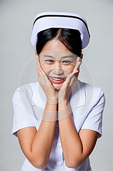 Portrait of very happy young Asian nurse