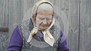 Portrait of very old smiling woman looking through the bowl of wheats` grains 4K