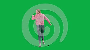 Portrait of victim on chroma key green screen background. Young girl running, scared expression, looking around, running