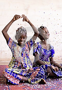 Portrait View of African ethnic group of children enjoying party indoors with confetti