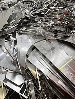 Portrait view of aluminium off cuts waste from a manufacturing process ready to be recycled