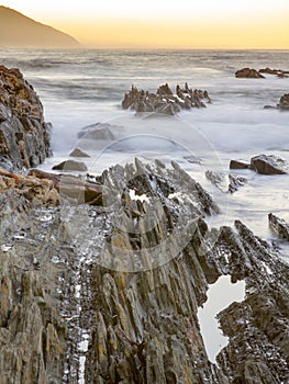 Portrait view of a rocky channel at the mouth of the Storms River in the Tsitsikamma Nature Reserve in South Africa