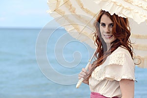 Portrait vintage woman with parasol by ocean