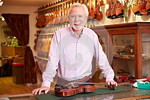 Portrait Of Violin Maker In Shop