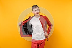 Portrait vogue shocked handsome young man 25-30 years in red leather jacket, t-shirt standing isolated on bright
