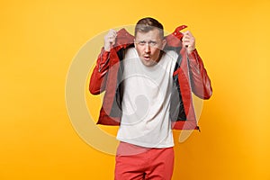 Portrait vogue shocked handsome young man 25-30 years in red leather jacket, t-shirt standing isolated on bright