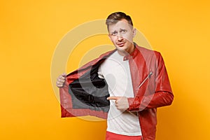 Portrait vogue shocked handsome young man 25-30 years in red leather jacket, t-shirt standing isolated on bright