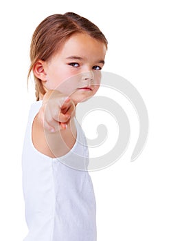 Portrait, vote and pointing with a serious child in studio isolated on a white background for choice. Kids, blame or