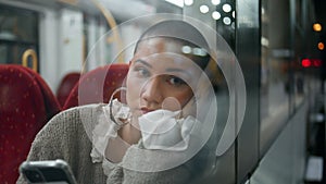 Portrait voyager sitting train looking mobile phone screen. Sad short hair woman