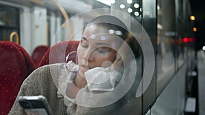 Portrait voyager sitting train looking mobile phone screen. Sad short hair woman