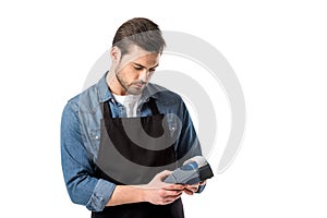 portrait of waiter in apron with cardkey reader in hands