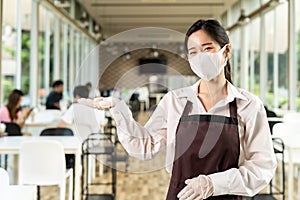 Portrait of waitress with facemask in New normal restaurant background