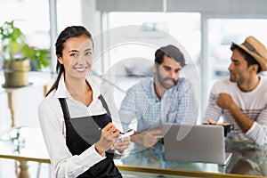 Portrait of waitress taking an order in cafe