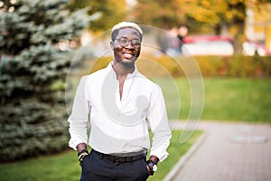 Portrait of walking stylish african american man wear on glasses outdoor. Street fashion black man.