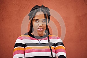 Portrait, wall and black woman with frustration, anger and upset on brown studio background. Face, African American