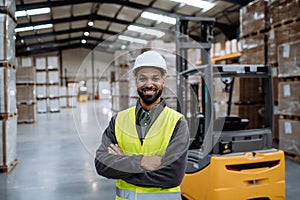 Portrait of warehouse worker standing by forklift. Warehouse worker preparing products for shipmennt, delivery, checking