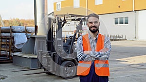 Portrait of warehouse worker wearing uniform against the background of the warehouse loader