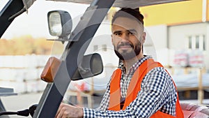 Portrait of warehouse worker wearing uniform on warehouse loader