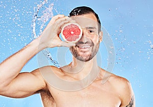 Portrait, water splash and skincare with a handsome young male posing for natural body care. Shower, water and