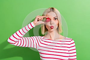 Portrait of wearing top young girl red lips kiss joke face headshot charming lady hiding strawberry  on green