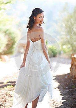 Portrait, wedding dress and back with woman, outdoor and sunshine with celebration and happiness. Person, park and girl