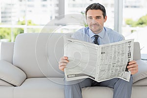 Portrait of a well dressed man reading newspaper