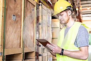 Portrait white caucasian worker with tablet in distribution warehouse