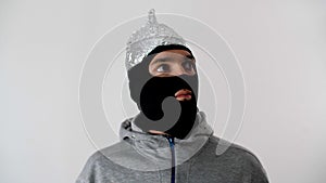 Portrait of a white man in a black balaclava. Thief or criminal is looking at the camera.