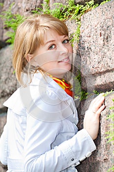 Portrait of a white woman against a stone wal