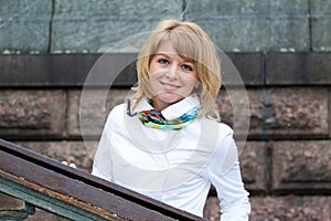 Portrait of a white woman against a stone wal