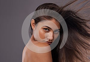 Portrait, wind and closeup of woman for hair care, treatment and blow dry with mockup space isolated on studio