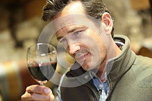 Portrait of winegrower holding glass of wine