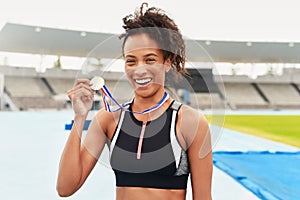 Portrait, winner and athlete with gold medal, sports and stadium for competition. Victory, racetrack or celebration for