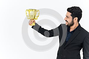 Portrait of Winning businessman celebrating with trophy award for success in business isolated on white background. Successful