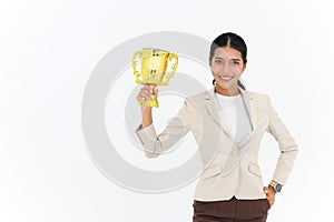 Portrait of Winning businesswoman celebrating with trophy award for success in business isolated on white background. Successful