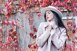 Portrait of a woman against red leaves