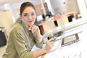 Portrait of woman architect working at office with tablet