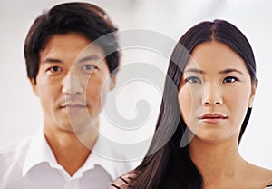 Portrait, woman and Asian man in office, serious and employees in corporate company with teamwork. Collaboration, girl