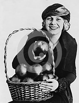 Portrait of woman with basket of apples