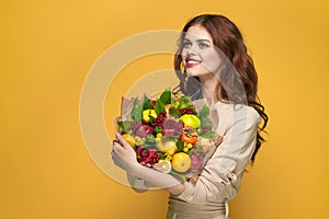 portrait of a woman beige coat fruit bouquet in hands present Studio Model